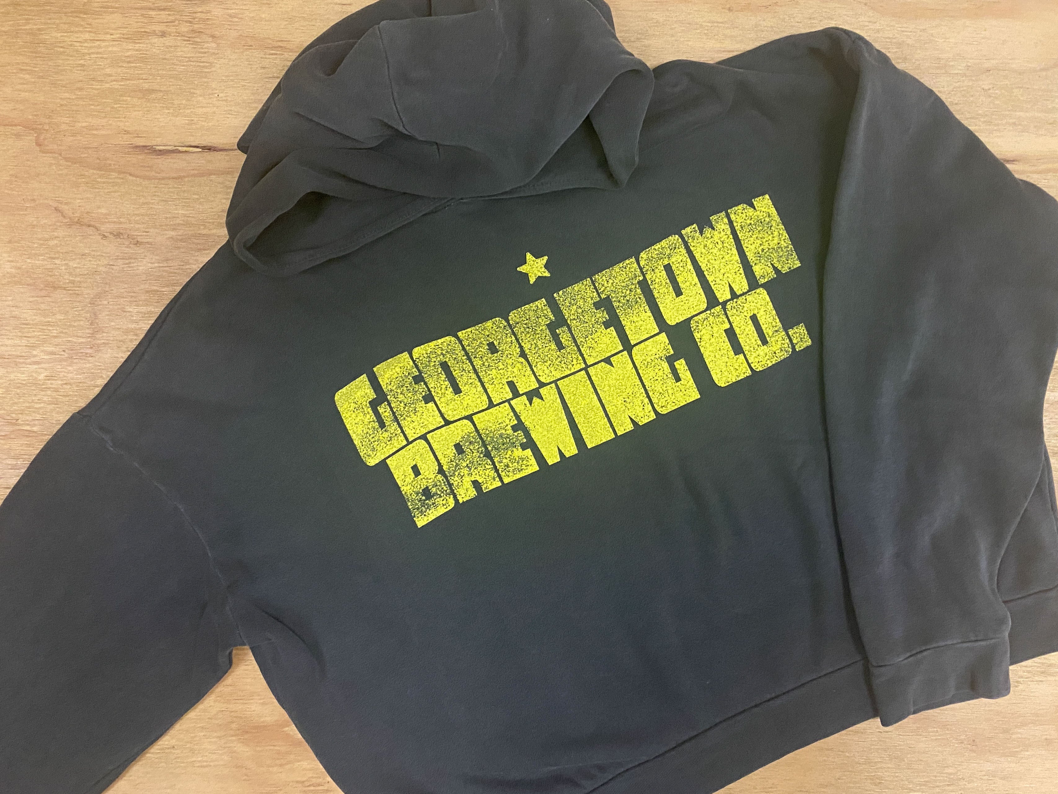 grey cropped sweatshirt with yellow text reading georgetown brewing co