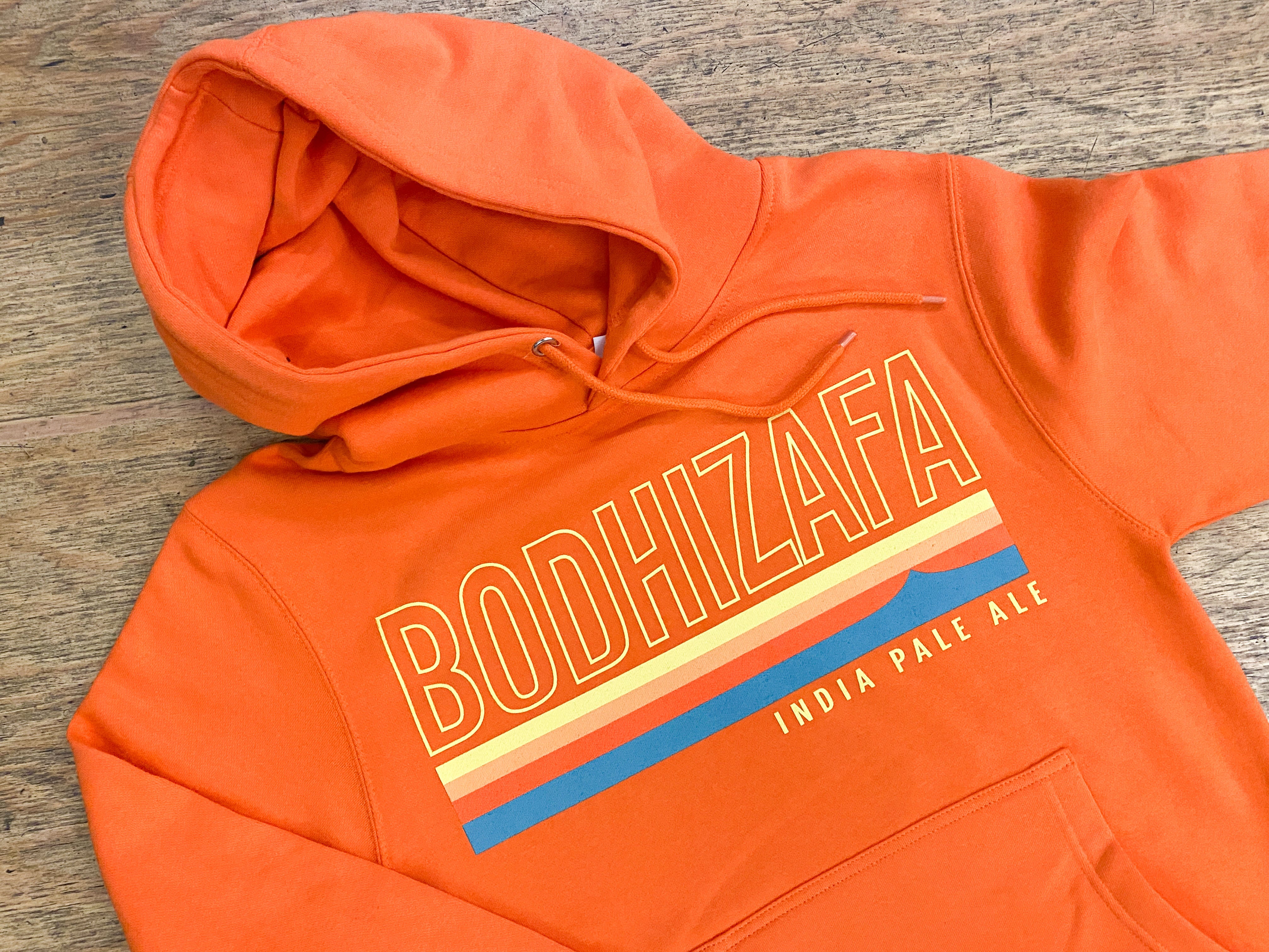 Orange hoodie with 'BODHIZAFA' text 