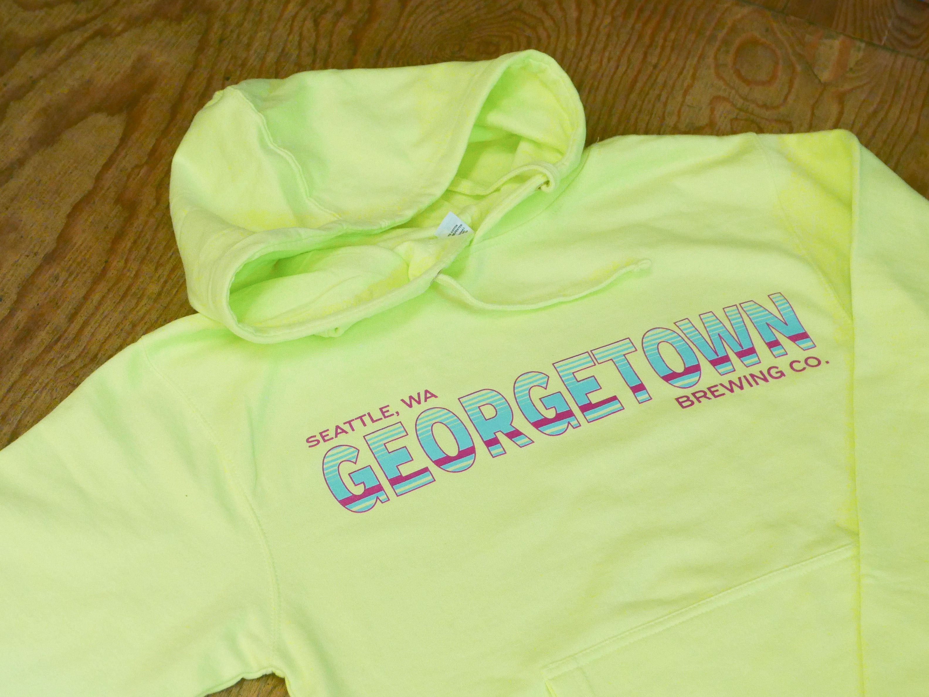 hi viz yellow sweatshirt with the words Seattle WA, Georgetown Brewing Co in hot pink and teal. 
