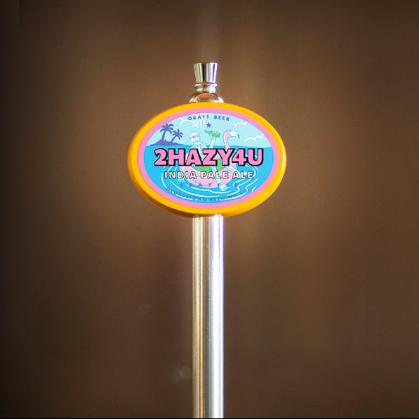Metallic beer tap handle with '2HAZY4U' branding against a brown background