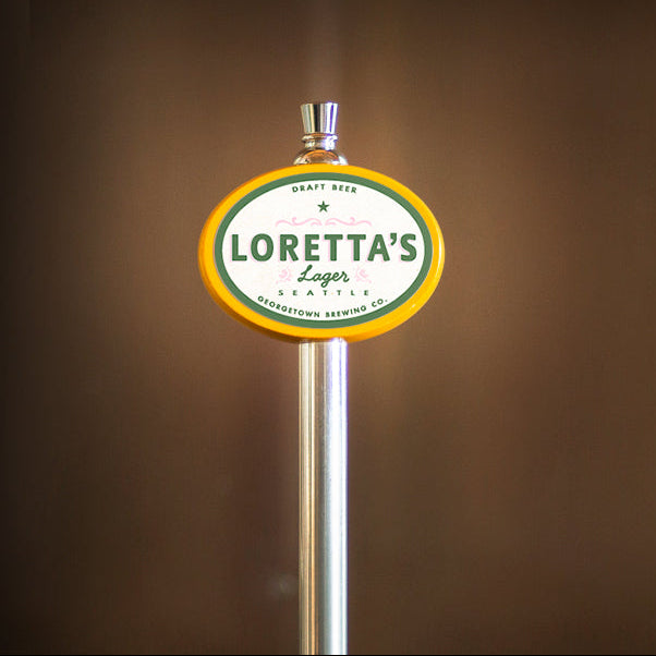 Loretta's Lager tap handle against a brown background
