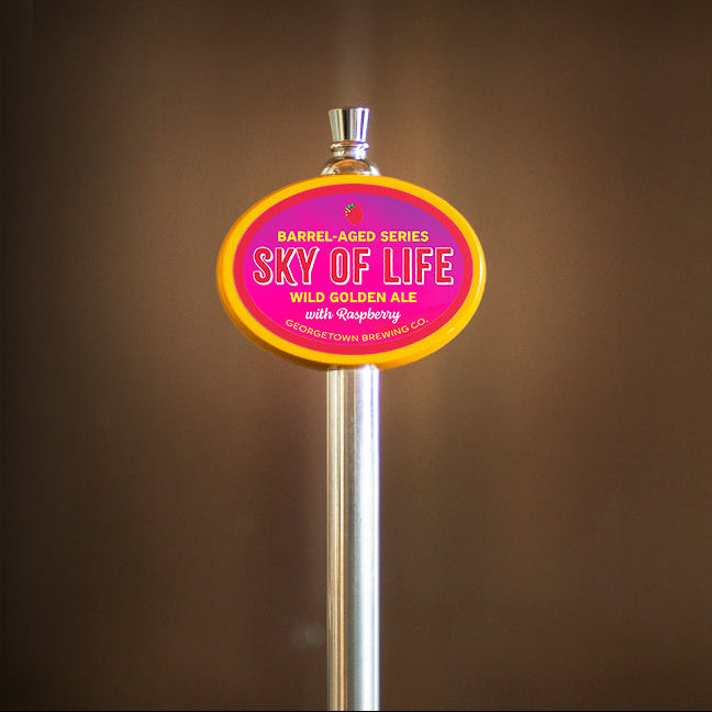 yellow oval tap handle with logo for Sky of Life barrel aged wild golden ale with raspberry
