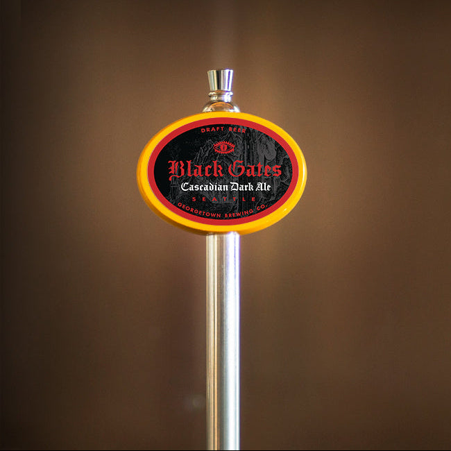 Beer tap handle with 'Black Gates' label on a brown background