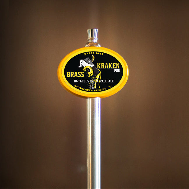 Beer tap with Brass Kraken Pub logo on a brown background