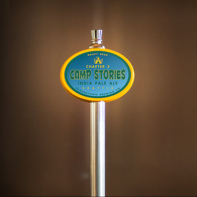 Beer tap with 'Camp Stories' label against a brown background