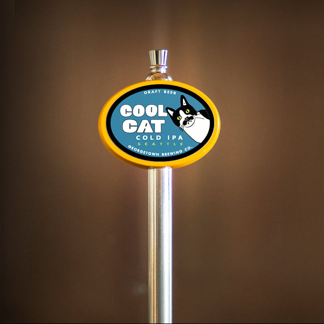 Beer tap handle with 'Cool Cat' label featuring a cat with a Freddy Mercury style moustache. 