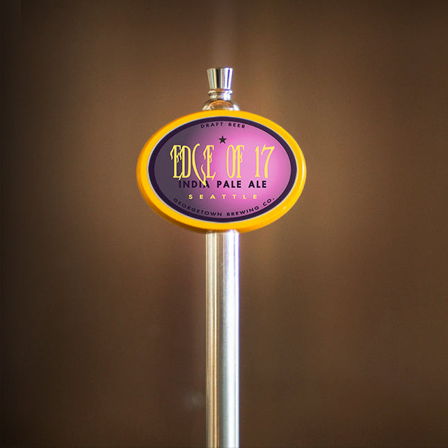 Beer tap handle with 'Edge of 17' label on a brown background