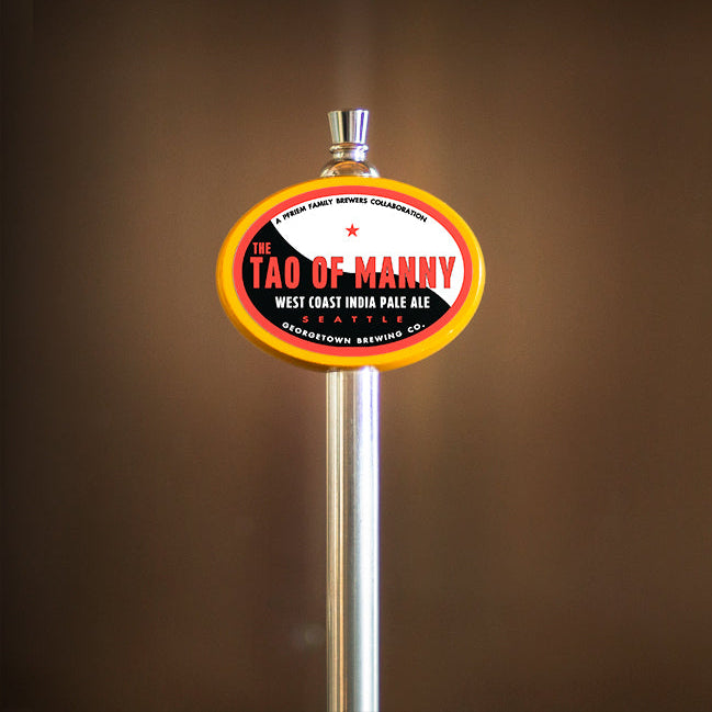 Beer tap handle with 'Tao of Manny' label against a brown background