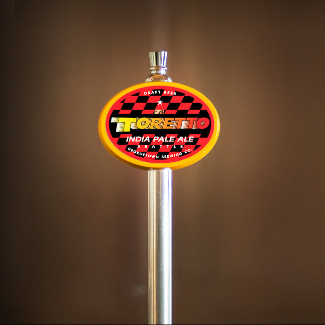 Toretto tap handle with a label on a brown background