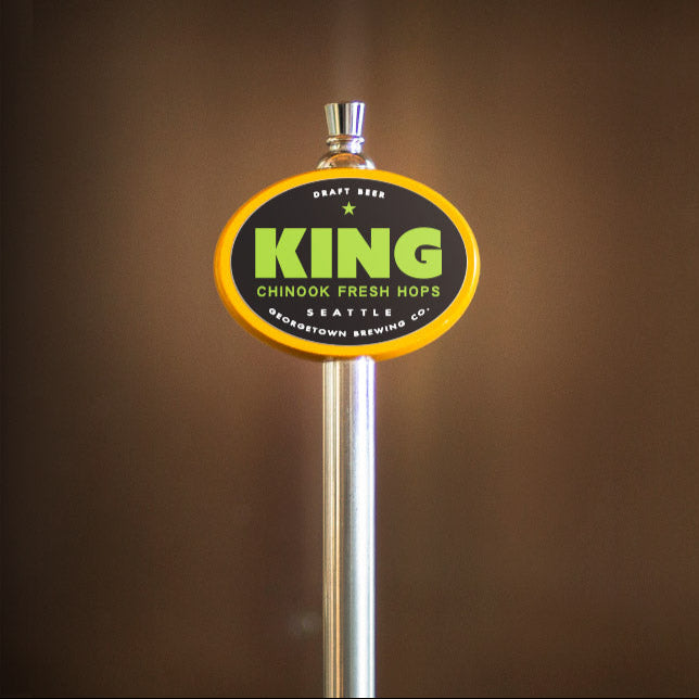yellow oval beer tap handle with 'King' branding on a brown background