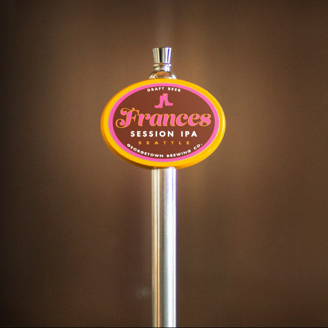 Beer tap handle with 'Frances Session IPA' label against a brown background