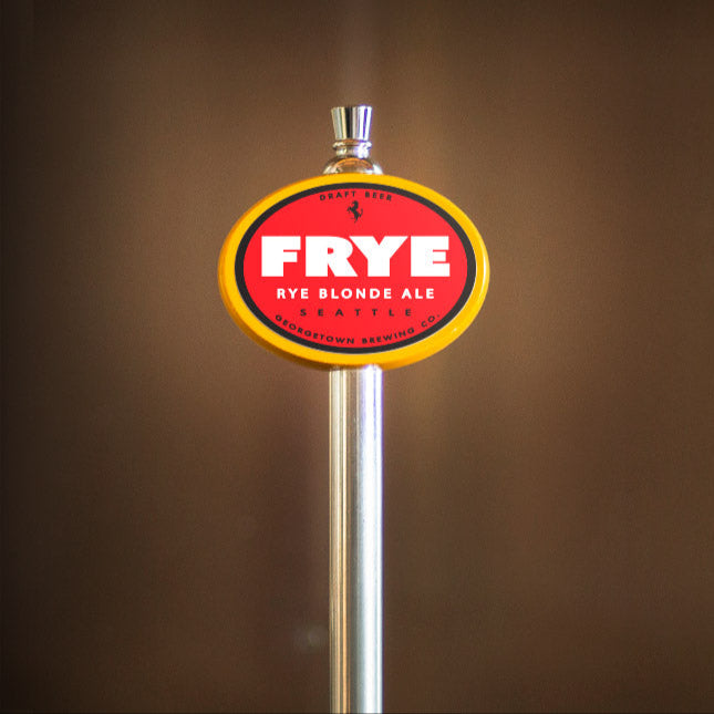 Frye beer tap handle against a brown background