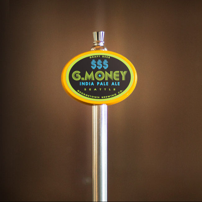Beer tap handle with 'G. Money' label on a blurred background