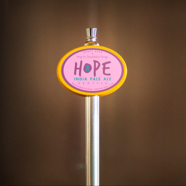 Beer tap handle with 'HOPE' label on a blurred background
