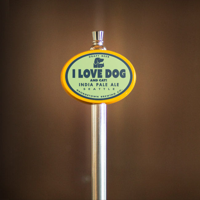 Beer tap handle with 'I Love Dog' branding against a brown background