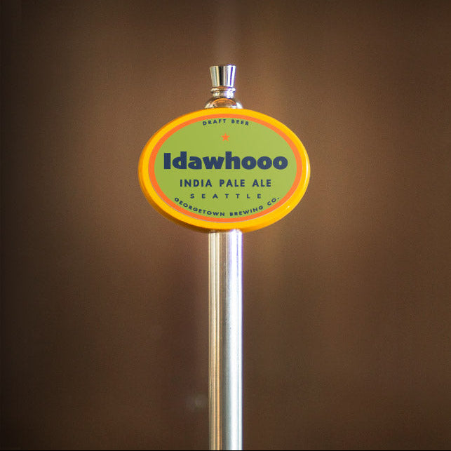 Beer tap handle with 'Idawhoo' label against a brown background