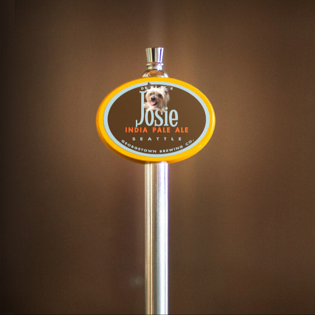 Beer tap handle with Josie IPA label on a brown background