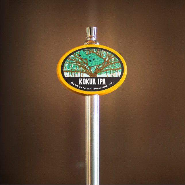 Beer tap handle with Kokua label on a brown background
