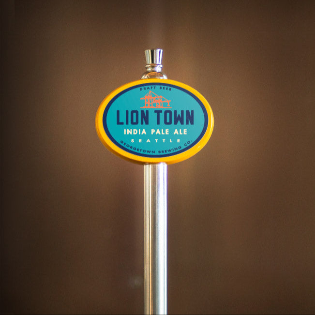 Lion Town India Pale Ale beer tap handle against a brown background