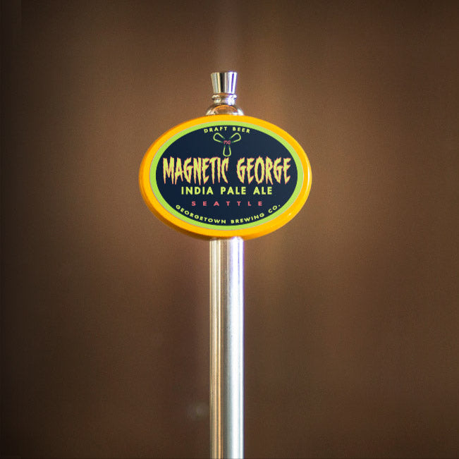 Magnetic George India Pale Ale tap handle on a brown background
