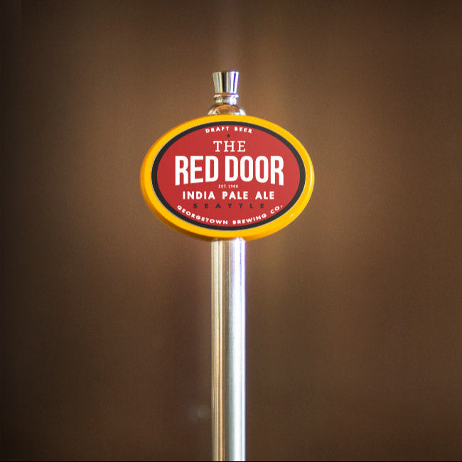 Beer tap handle with 'The Red Door' label on a brown background