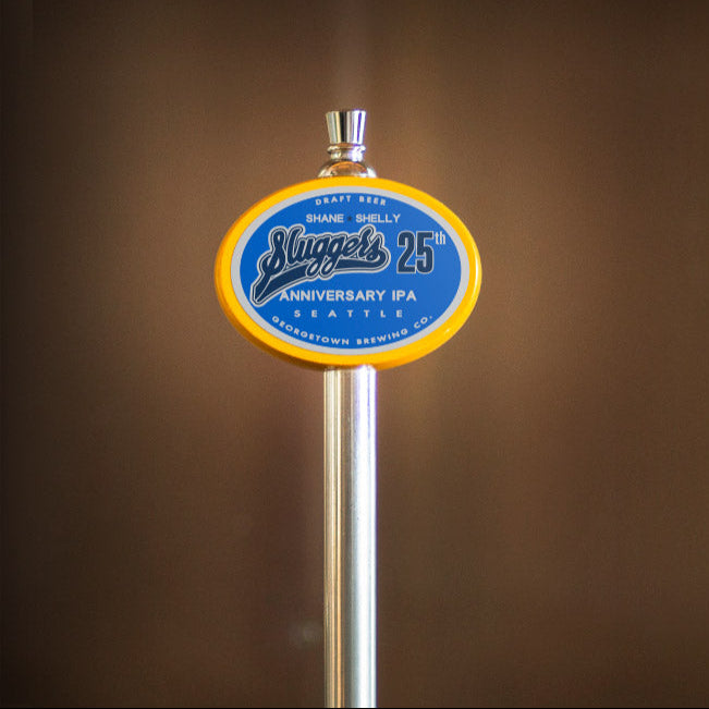 beer tap handle with a blue and yellow Slugger's label on a brown background