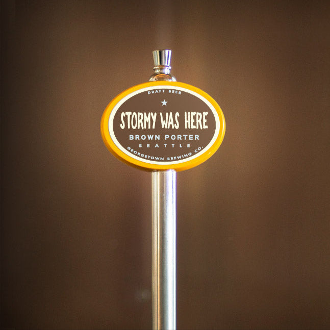 Beer tap handle with 'Stormy Was Here' label against a brown background