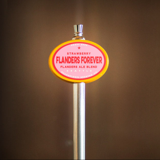 Beer tap handle with 'Strawberry Flanders Forever' label on a blurred background