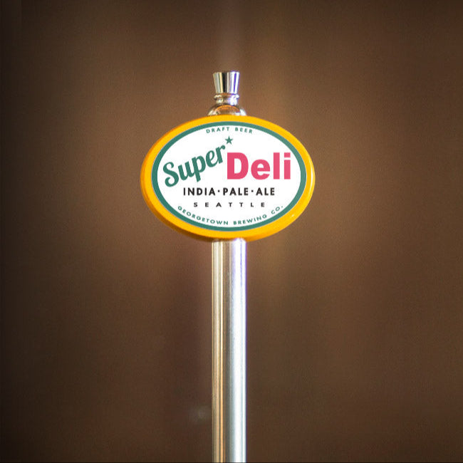 Super Deli India Pale Ale tap handle against a brown background