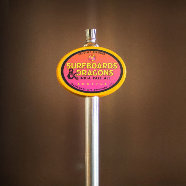 Beer tap handle with 'Surfboards & Dragons' label against a brown background