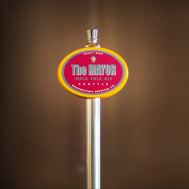 Beer tap with 'The Mayor' label against a brown background