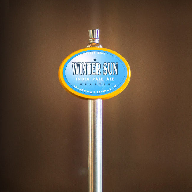Beer tap with 'Winter Sun' label against a brown background