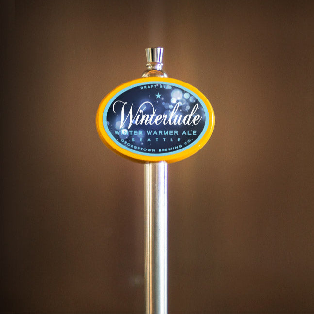 Winterlude beer tap handle with a blurred brown background
