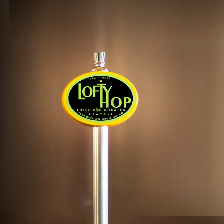 Lofty Hop beer tap handle on a brown background