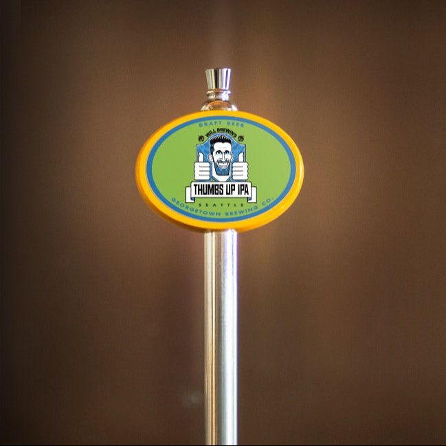  beer tap handle with Thumbs Up label on a brown background